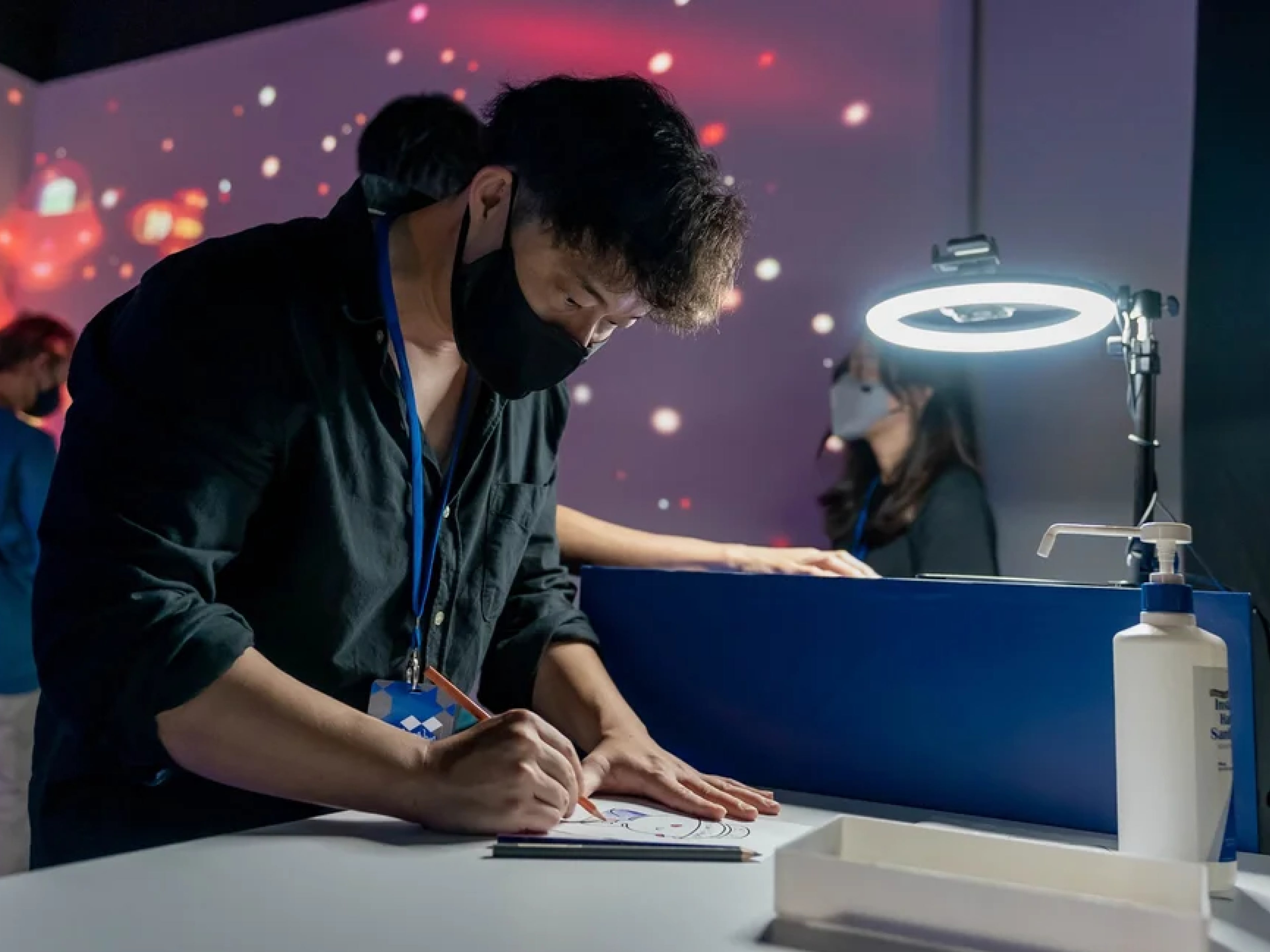 A participant working at a table during a technology programme.