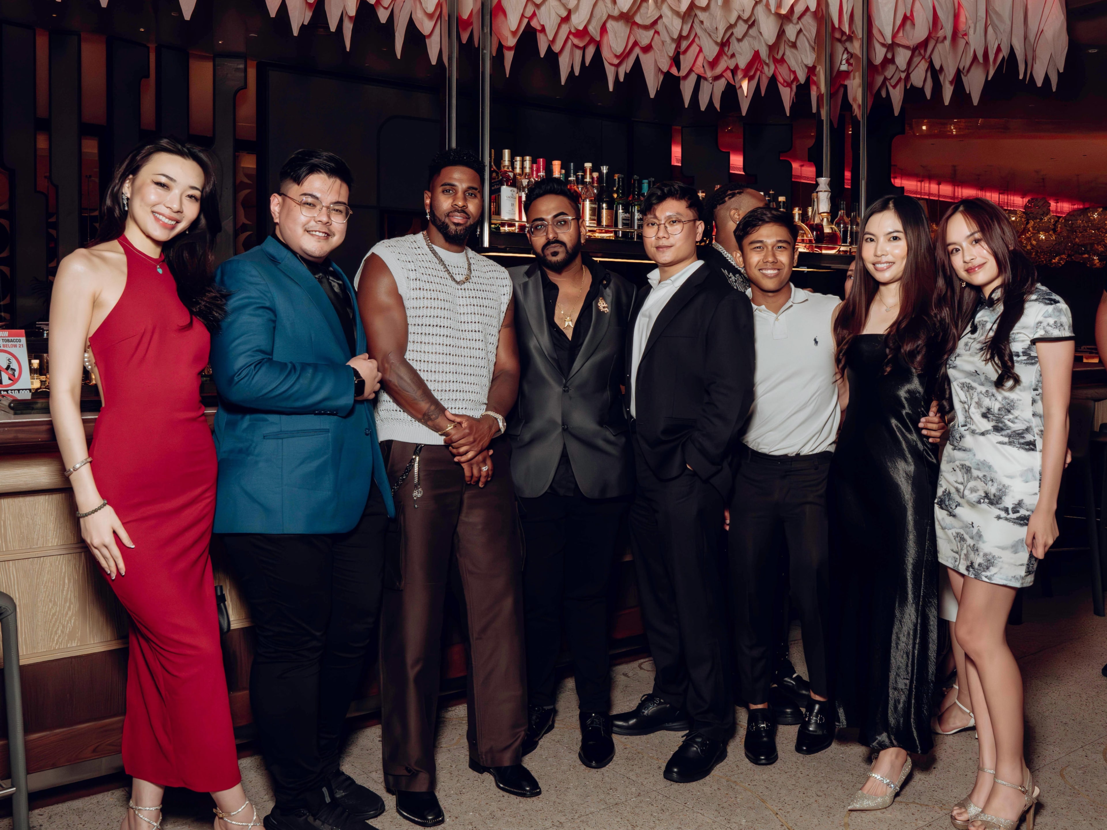 Guests posing together at an APEX AURA gathering in Singapore.